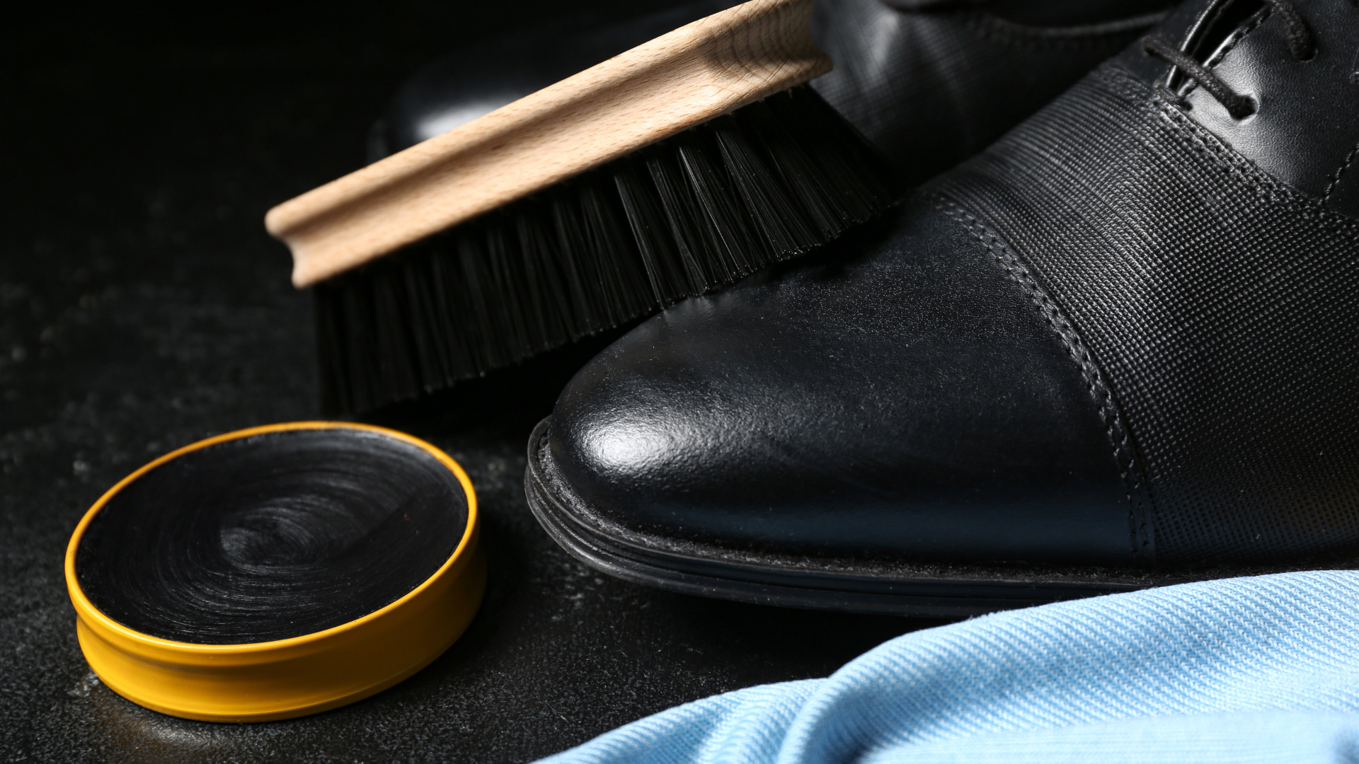 Zestaw do pielęgnacji butów: szczotka, krem, szmatka i but skórzany